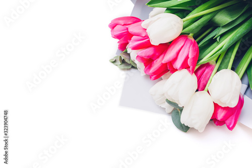 Spring flowers isolated on white background. Women's day. Bouquet of white and ping tulips. Present for Mother's day.