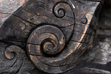 beautiful figures carved into a tree nature landscape background. A wooden figure carved in a tree trunk.
