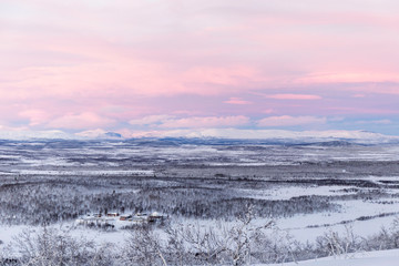 winter mountain landscape with pink sky