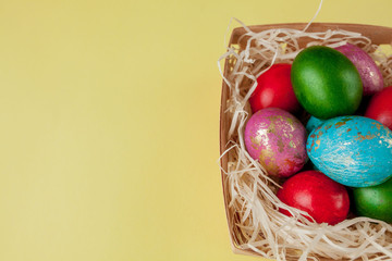 Happy Easter eggs yellow background. Golden shine decorated eggs in basket, for greeting card, promotion, poster. Copy space