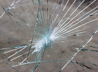 Broken car windshield, cracks in glass due to accident.