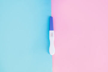 Positive pregnancy test with two strips on pink