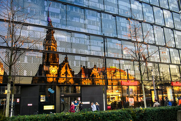 Reflection of Evangelical Reformed Church in modern glass building during sunset. Leipzig, Germany....