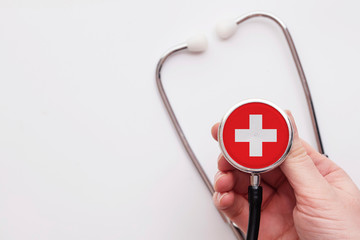 Switzerland healthcare concept. Doctor holding a medical stethoscope.