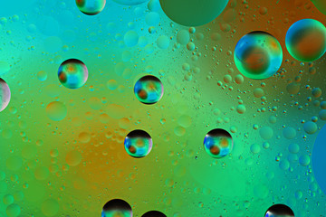 iridescent bubbles on colored green background