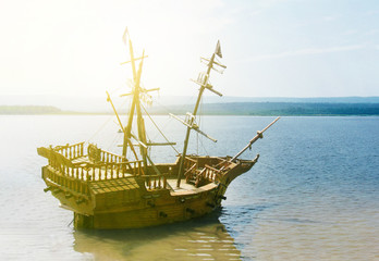 old wooden ship with mast anchored in the sun