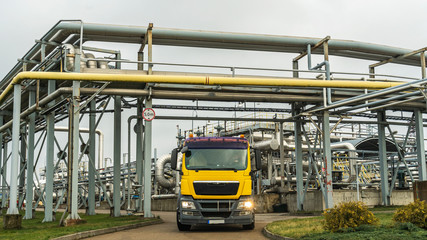 Panoramic view of the oil terminal with yellow tanker truck. Petrochemical concept.
