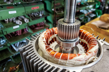 Skilled industrial worker assembling electric motor, detail