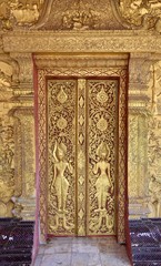 Fototapeta na wymiar Wat May Souvannapoumaram Gilded Wall Reliefs and Doors, Luang Prabang, Laos
