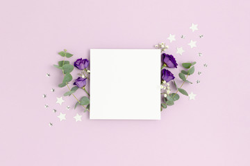 Square paper card mockup. Floral composition with silver confetti on a purple background.