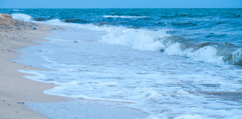 Fototapeta na wymiar Beautiful turquoise sea. Beach and sand. Sea waves and foam. Vacation and rest