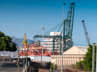 Image of cargo port terminal at ocean harbour with floating docks and hevy lifting crane