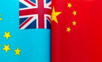 fragments of the national flags of Tuvalu and China in close-up