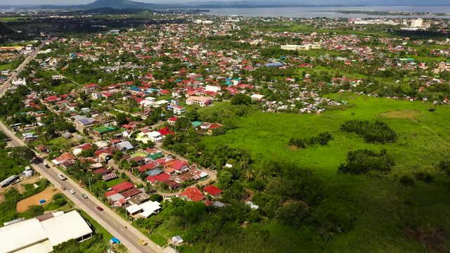 Road and streets in the town of Tacloban, Philippines. Car traffic, top view. Cityscape in the asian town.