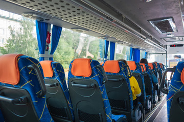 transport, car travel, tourism and equipment concept - tourist salon and bus places. People are sitting in the cabin. Selective focus © lunika