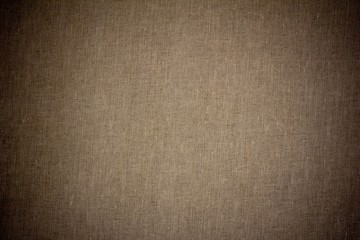 background texture of dark grey canvas fabric with vignette