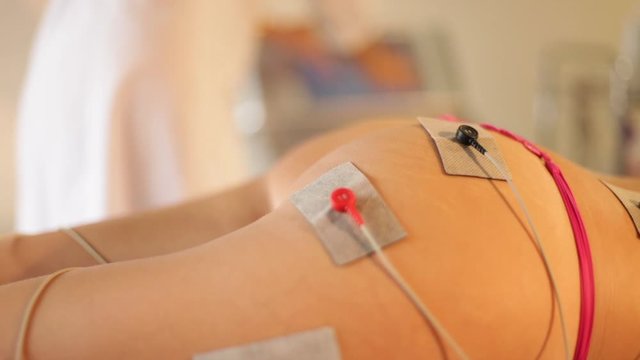 Muscle contractions in electro stimulation therapy of the butt, legs and back. Hardware cosmetology and antiage therapy