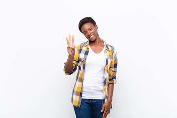 young pretty black womansmiling and looking friendly, showing number three or third with hand...