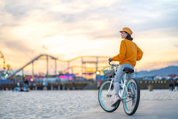 Smiling woman on Santa Monica beach at sunset