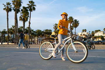 Young girl with bike on Santa Monica Beach