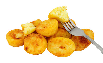 Group of crispy roasted potatoes isolated on a white background
