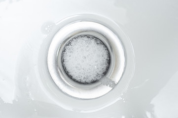 Foamy wash after taking a shower in the bathroom drain.