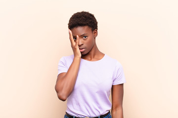young pretty black womanfeeling bored, frustrated and sleepy after a tiresome, dull and tedious...