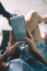 Woman using phone while lounging on street in free time