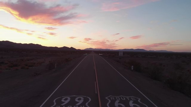 Aerial shot over old Route66 at sunrise with mountains in the background