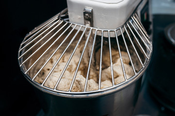Bread Mixer In Bakery, mixing dough for baguettes in a bakery