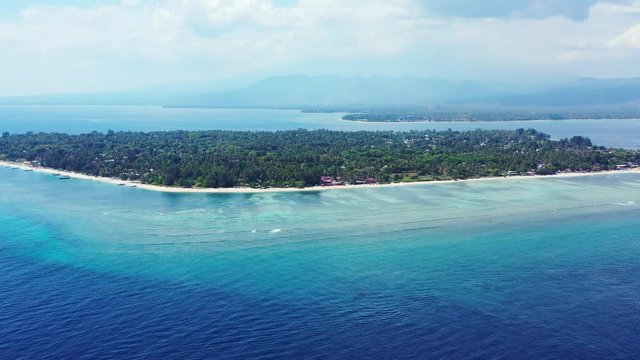 Gilli islands, Bali, aerial seascape on a foggy day. Lombok and Mount Rinjani in the background covered in the clouds
