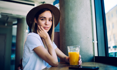 Sensual young lady with juice in cafe