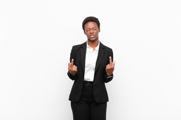 young pretty black womanfeeling provocative, aggressive and obscene, flipping the middle finger,...