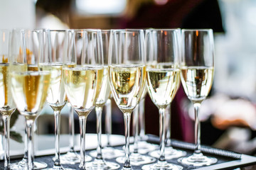Glasses of champagne and sparkling wine served on a tray during charity event