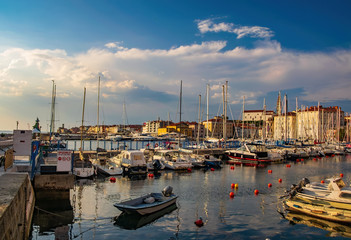 Fototapeta na wymiar Harbour of Piran, Slovenia. Yachts and boats under picturesque sky