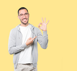 Happy young man doing an all right gesture