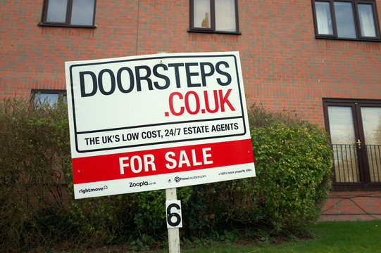 Bracknell, England - February 18, 2020: Residential For Sale sign in front of an apartment block, posted by the Doorsteps estate agency. The agency started in 2016 and provides an online service