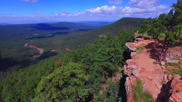 Aerial photography, Drone shot hanging off a cliff over a VALLEY of trees on a sunny day in the forest. Near the Mogollon Rim in Payson, AZ