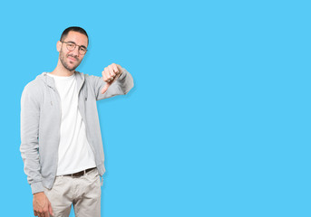 Fototapeta premium Serious young man doing a gesture of defeated