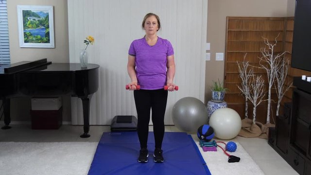 Woman Exercising Dumbbell Inside, Still Long Angle Shot