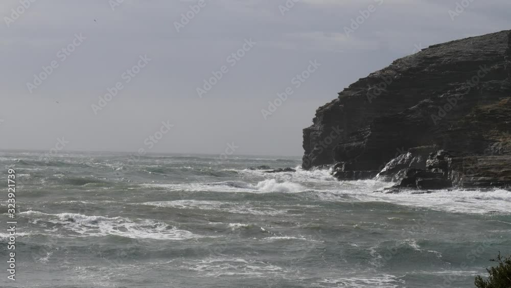 Sticker spanish beach sea waves at cloudy rainy weather. cala reona in cabo de palos. mediterranean sea land