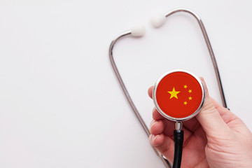 China healthcare concept. Doctor holding a medical stethoscope.