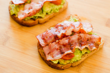 avocado toast with cherries tomatoes and bacon