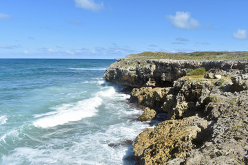 ocean waves crash against rocks