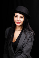 Beautiful woman portrait with a big hat. Vintage look. Fashion makeup. The hat covers half the face