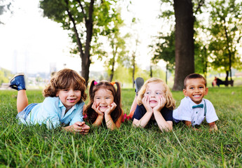 Fototapeta na wymiar group of preschool children playing in the Park on the grass