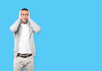 Concerned young man doing a gesture of relief