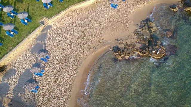 Aerial tilt down shot of a city near a beautiful beach at Zakynthos