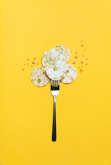Vegeterian bean chips and lentils on yellow background. Top view.