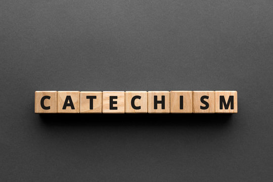 Catechism - words from wooden blocks with letters, principles of Christian religion catechism concept, top view gray background